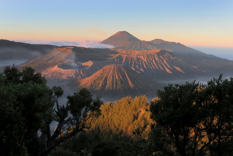 The view of four mountains; Mount Bromo (left), Mount Batok (front), Mount Widodaren (right) and Mount Semeru (behind) as seen from Penanjakan 1 view point at Bromo Tengger Semeru National Park (TNBTS).