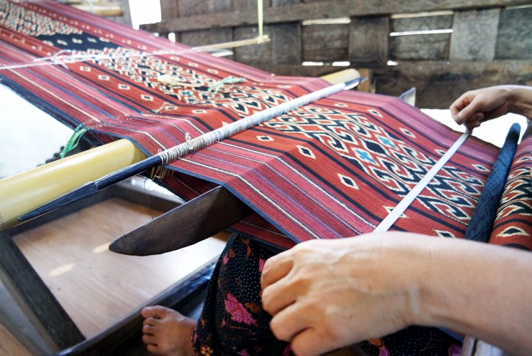 Colorful: A weaver works on a piece of Toraja fabric in South Sulawesi.