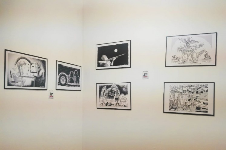 Cartoon editorials by Budhi Button at The Jakarta Post booth at Art Jakarta 2018