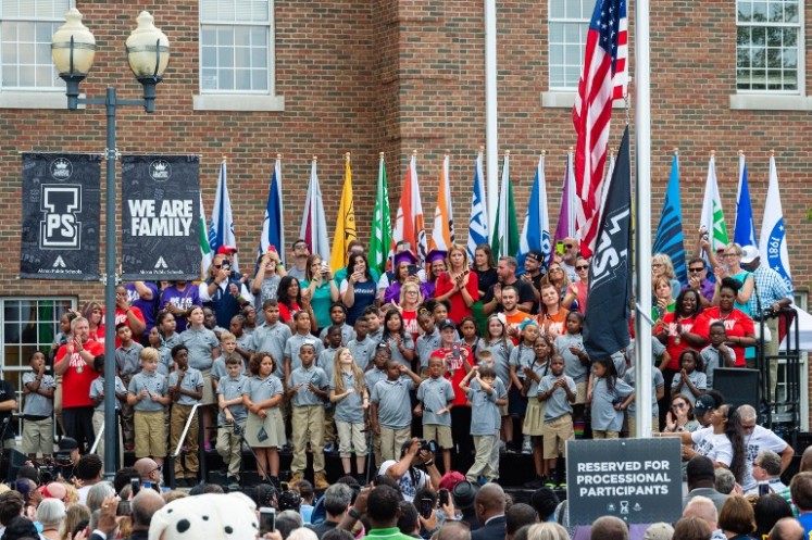 Gloria James, mother of LeBron James, raises the flag during the opening ceremonies of the I Promise School on July 30, 2018 in Akron, Ohio. The School is a partnership between the LeBron James Family foundation and the Akron Public School and is designed to serve Akron's most challenged students. 