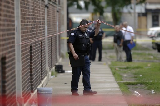 Chicago Police officers and detectives investigate a shooting where multiple people were shot on Sunday, August 5, 2018 in Chicago, Illinois. In the last 24 hours over 30 people have been shot and at least 2 killed across Chicago including five mass shootings, where four or more victims were shot at one location. 