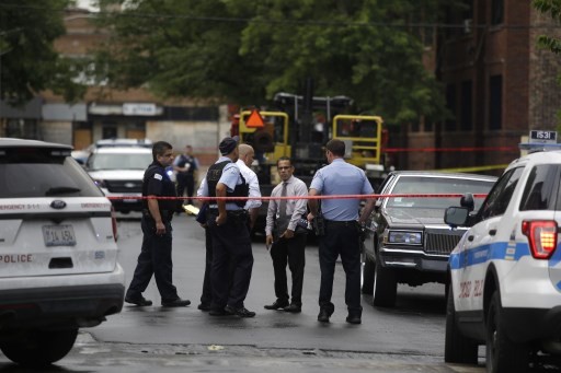 Chicago Police officers and detectives investigate a shooting where multiple people were shot on Sunday, August 5, 2018 in Chicago, Illinois. In the last 24 hours over 30 people have been shot and at least 2 killed across Chicago including five mass shootings, where four or more victims were shot at one location. 