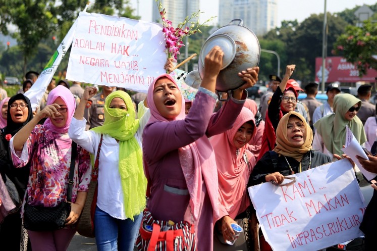 Women grouped in the Emak-Emak Militan, (militant moms) stage a rally on July 18 in at the State Palace in Central Jakarta. The women protested about economic issues, including rising prices, and criticized President Joko 