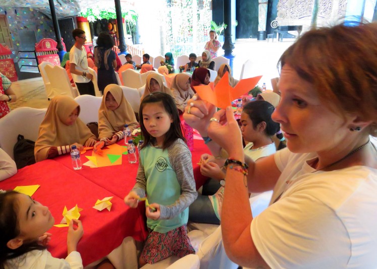 Mademoiselle Maurice shares her origami art with orphaned children in Malang, East Java. 