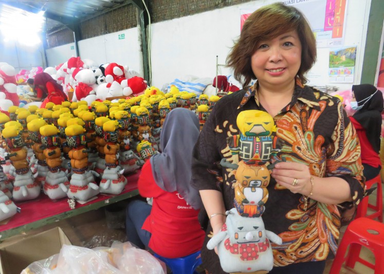 Owner of Istana Boneka, Susan Soewono, poses with mascot dolls of the 2018 Asian Games.