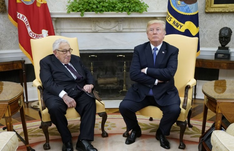 US President Donald Trump (right) meets with former US Secretary of State Henry Kissinger in the Oval Office of the White House on October 10, 2017 in Washington, DC. 
