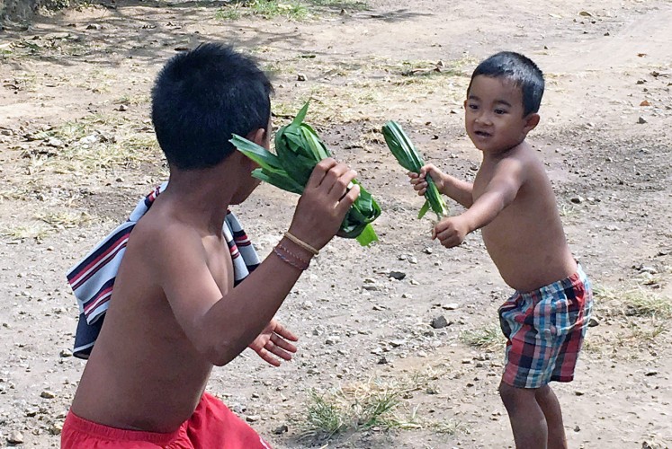 Street fighting: Children in the village start practicing the ritual at an early age, emulating their family members by play-fighting in the street.