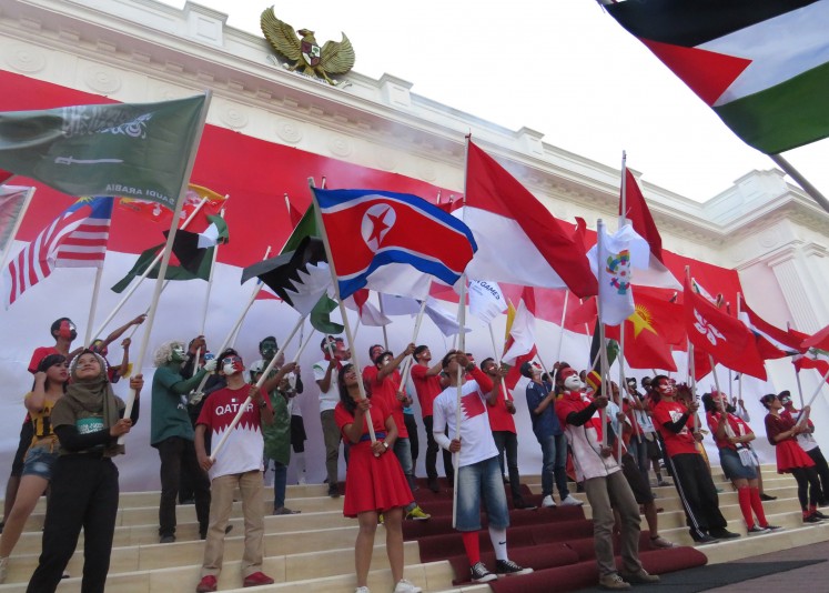 Forty-five national flags of countries participating in the Asian Games were carried at Jatim Park by performers wearing the national dress of each country.