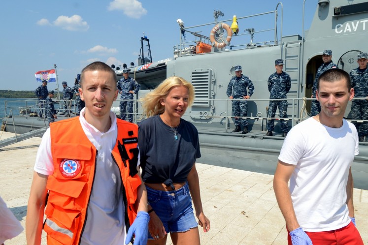 British tourist Kay Longstaff (C) exits Croatia’s coast guard ship in Pula, on August 19, 2018, which saved her after falling off a cruise ship near Croatian coast.