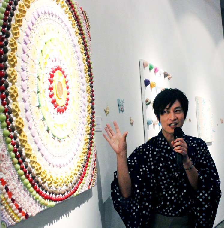 Food talk: Japanese artist Osamu Watanabe, dressed in a traditional kimono, explains the idea behind his mouthwatering piece titled MANDARA.