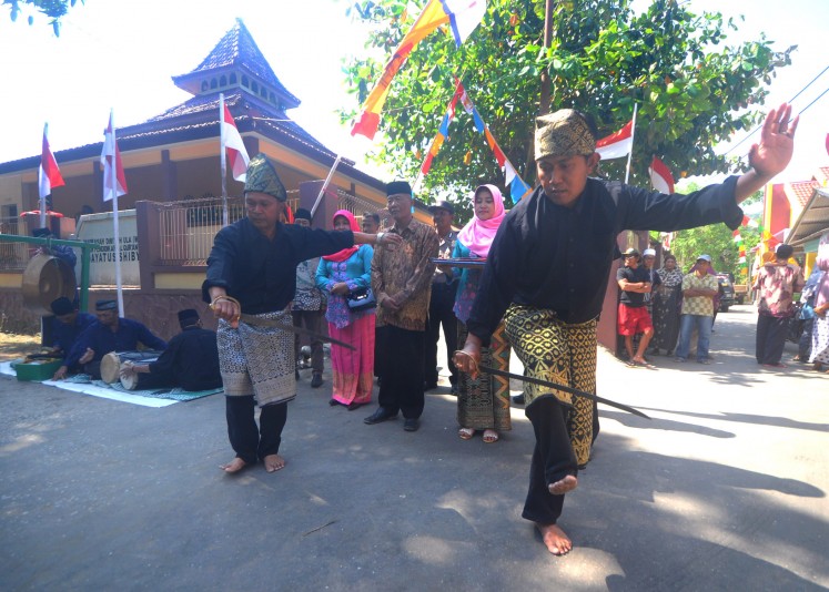 Locals perform Bawean-style pencak silat.
