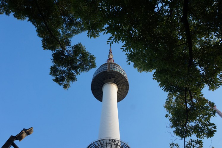 The iconic N Seoul Tower against a bright blue sky.