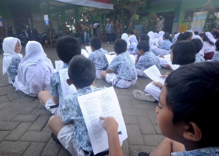 Students read song lyrics during Arbanat String Ensemble's performance on Aug. 29. 