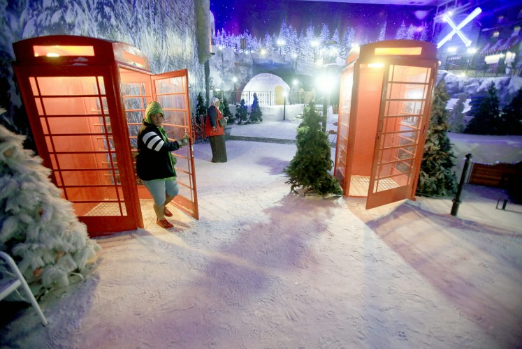 Mock winter: A visitor experiences the freezing cold in Snow World at Resorts World Genting, Malaysia.