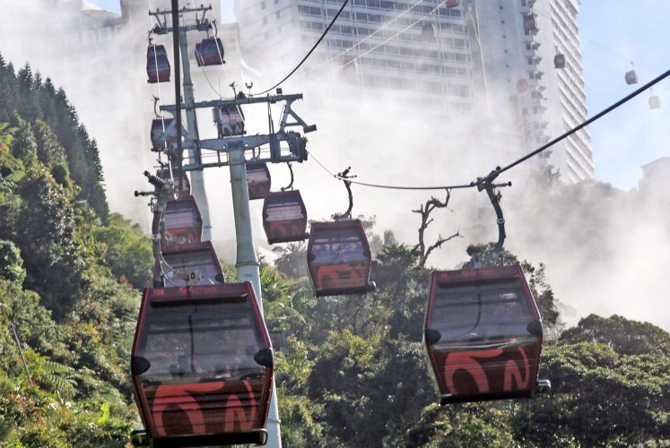 Floating: SkyWay cable cars glide through the clouds as they travel from Sky Avenue Station at Resorts World Genting, Malaysia.