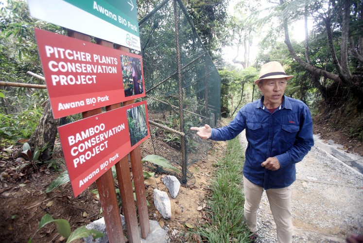 Conservationist: Eddy Chan points to a sign board inside the Awana Bio Park at Resorts World Genting, Malaysia. The Bio Park offers excursions into the jungle dubbed the “Fashion Forest”.