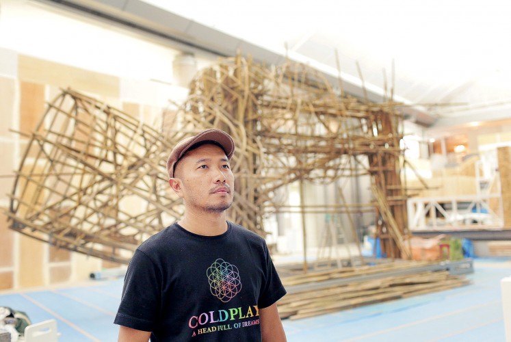 Work in progress: Artist Joko Dwi Avianto poses with his artwork for the exhibition at the center of Yokohama Museum of Art’s Grand Gallery in Japan. 