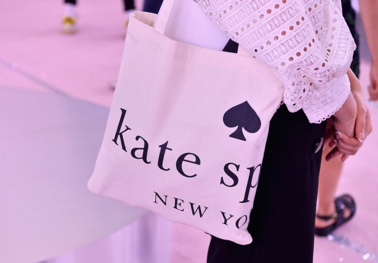 A guest wears a Kate Spade bag during the Kate Spade New York Fashion Show during New York Fashion Week at New York Public Library on September 7