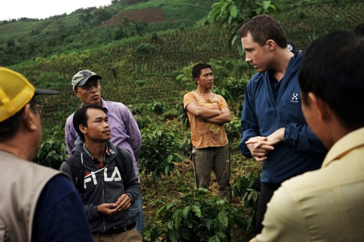 Erlend Falch (R) from the UN Office on Drugs and Crime conferring with local officals at a coffee plantation in Houaphan province, northern Laos. Wedged between five countries, reclusive Laos has for decades played a starring role in the 