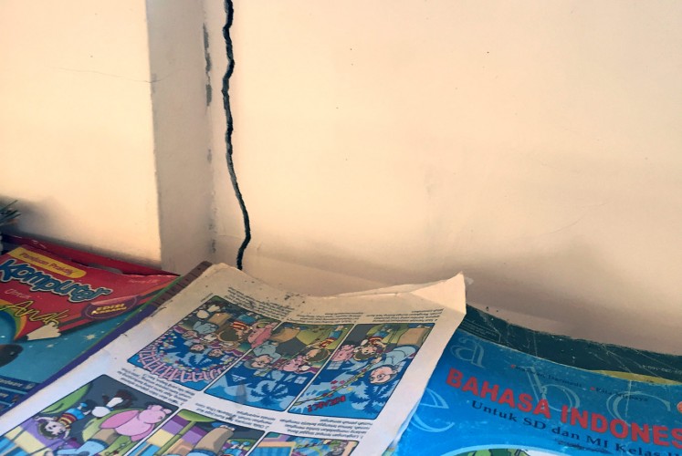 Fractured: A crack in a wall is visible in the school’s recently constructed library. The building still stands but deep fractures mean it could collapse in another earthquake. 
