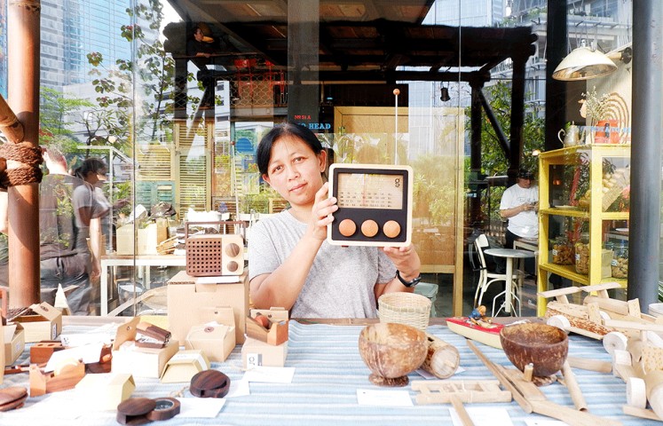 Take your pick: A woman shows off Singgih’s works, which were on display during an event in Jakarta. 