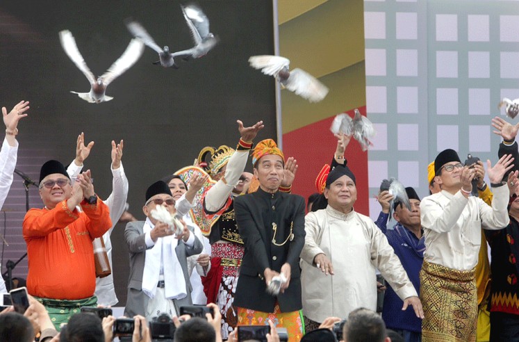 Give peace a chance: President Joko “Jokowi” Widodo (center), who is running for a second term, and his running mate Ma’ruf Amin (second left), along with presidential candidate <a href=