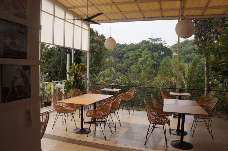 A cafe in Ciumbuleuit, Bandung, overlooking a lush mountain area.