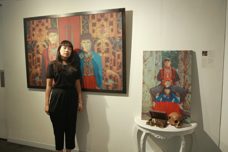 Rapha Lisa stands in front of her works at 'Chrysalis' fashion photography exhibition on Thursday, Sept. 27 at Artotel Thamrin, Central Jakarta. Although based on mythologies and history, Rapha still gives some twists to her 'Memento Mori'. 