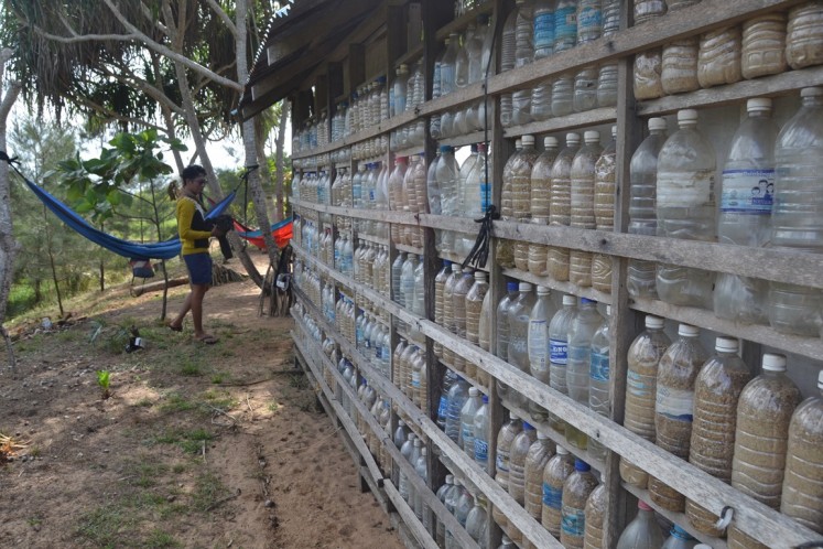 A small function hall at Sungai Belacan camp in West Kalimantan has walls made of used plastic bottles found on the nearby beach.