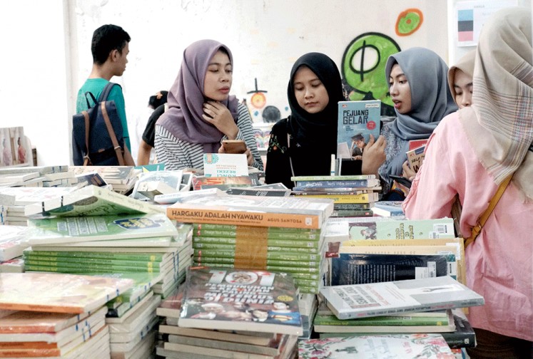 Bookworms: Visitors browse through books on offer at the Book Market held during Gramedia’s Readers Fest at Kota Tua in West Jakarta.