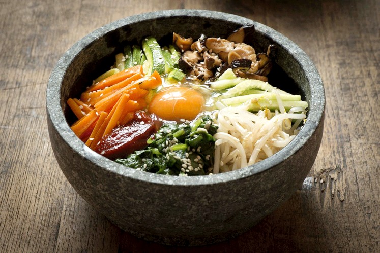 Hot and spicy: Korean dish bibimbap, which literally means “mixed rice”, is served as a bowl of warm white rice topped with sautéed vegetables, gochujang (Korean chili pepper paste) and soy sauce with raw or fried egg and slices of meat.