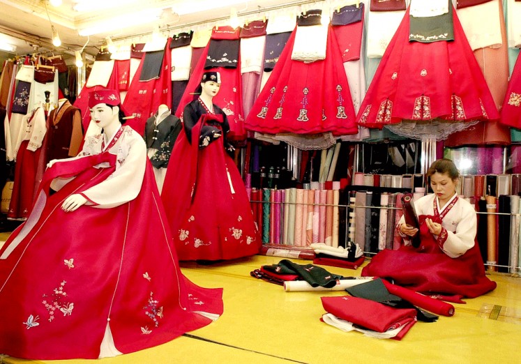 Korean style: A South Korean shop tailor checks fabric at the hanbok (traditional dress) market in Gwangju city, South Korea.