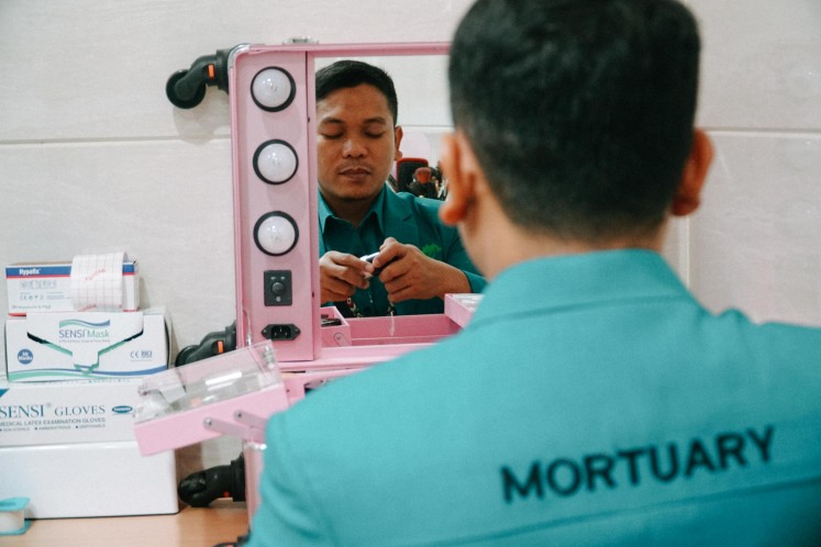 Fakhru Agnia prepares his makeup kits at Rumah Duka Sentosa in Central Jakarta.