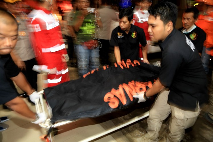 A forensics team carries bodies of the victims of Lion Air flight JT610 to Sukanto National Police Hospital, East Jakarta, on Monday. 