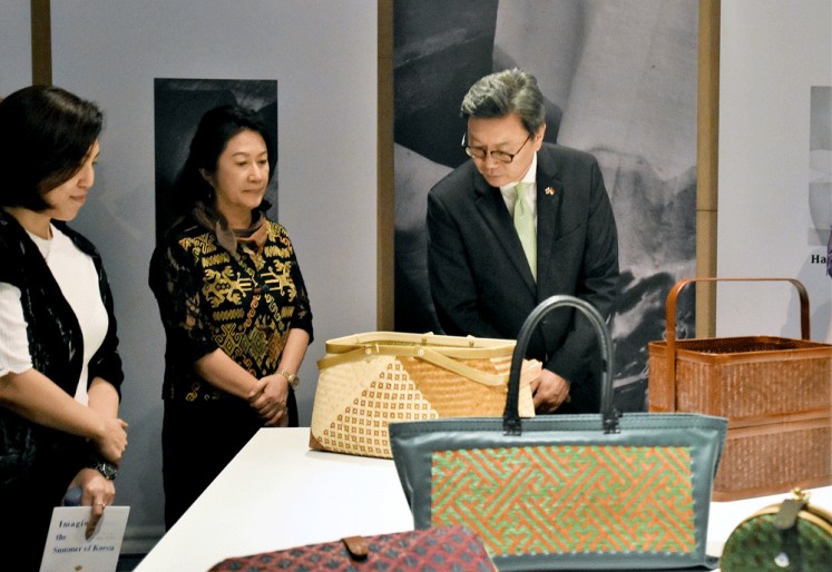 Admiration: South Korean ambassador to Indonesia Kim Chang-boem (right) observes a woven bamboo bag shown at the Imagine the Summer of Korea exhibition at the Korean Cultural Center Indonesia. 