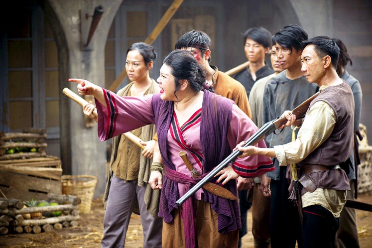 Joanne Kam (center), the queen of Malaysian stand-up comedy, gets serious for her role in the period action drama. She plays Chi, the madam of Grisse’s brothel. Image: HBO Asia