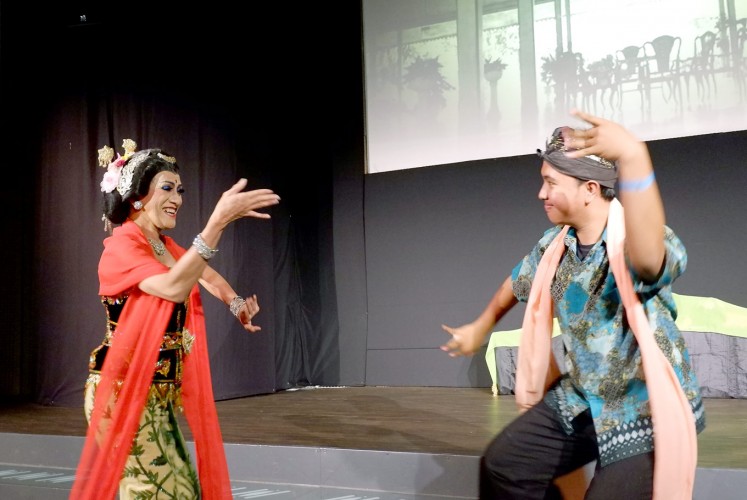 Sway with me: Didik (left) performs lengger senggot with a member of the audience. Despite its feminine characteristics, the dance has been performed by men in Banyumas, Central Java, since the 18th century.