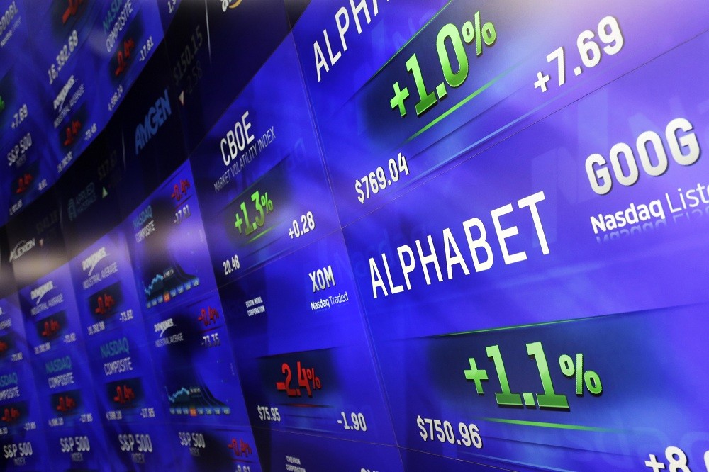 Electronic screens post prices of Alphabet stock, Monday, Feb. 1, 2016, at the Nasdaq MarketSite in New York. Alphabet, the parent company of Google, reports quarterly earnings Monday. 