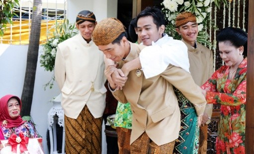 President Joko “Jokowi” Widodo carries his eldest son <a href=