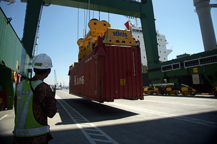 Gearing up: A worker monitors the loading process of a container at the Tanjung Perak port in Surabaya, East Java, in this undated photo.