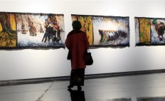 A visitor soaking in Yee I-Lann's epic work The Orang Besar Series (2010) at Ilham gallery's Love Me In My Batik: Modern Batik Art From Malaysia And Beyond exhibition.