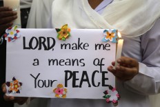A Pakistani nun holds a candle during a vigil for victims of the Sunday's deadly suicide bombing in a park, Monday, March 28, 2016 in Lahore, Pakistan. Pakistan's prime minister on Monday vowed to eliminate perpetrators of terror attacks such as the massive suicide bombing that targeted Christians gathered for Easter the previous day in the eastern city of Lahore, killing at least 70 people. AP/ K.M. Chaudary