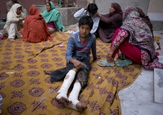 Fahd Ali, 10, injured in a bomb attack that killed  his parents and a sister and wounded two sisters, sits outside his home in Lahore, Pakistan, Monday, March 28, 2016. Pakistan's prime minister on Monday vowed to eliminate perpetrators of terror attacks such as the massive suicide bombing that targeted Christians gathered for Easter the previous day in the eastern city of Lahore, killing 70 people. AP/ B.K. Bangash