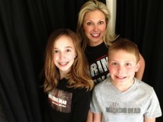 This March 29, 2016 photo released by Ericka Calcagno, center, shows her with her daughter Gina Binder, 12, left, and son Jean-Luc Binder, 9, wearing T-shirts from, "The Walking Dead," at their home in Farmington Hills, Mich. Calcagno says her husband first introduced her to the series and her kids were intrigued by their conversations about it. And now they all watch the popular zombie show as a family.