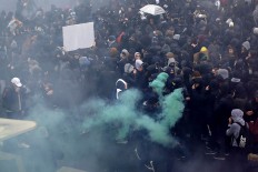 Youth demonstrate in Paris, Thursday, March 31, 2016. Student organizations and employee unions have joined to call for protests across France to reject the Socialist government's bill, which they consider as badly damaging hard-fought worker protections. AP Photo/Francois Mori