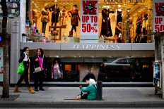In this Wednesday, Feb. 10, 2016 photo, a Syrian refugee woman begs for money in front of boutiques on a sidewalk, in Beirut, Lebanon. It is one of the most visible signs of the refugee crisis that has put an immense strain on neighboring countries and destabilized Europe. On Lebanon shopping streets, roundabouts and traffic lights, beggars are seen stretching their hands for money.
