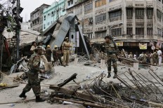 Security officers work on the area of a collapsed overpass in Kolkata, India, Friday, April 1, 2016. The overpass spanned nearly the width of the street and was designed to ease traffic through the densely crowded Bara Bazaar neighborhood in the capital of the east Indian state of West Bengal. About 100 meters (300 feet) of the overpass fell, while other sections remained standing. 
