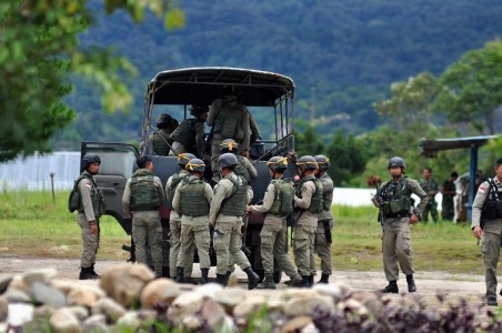 Members of the National Police Mobile Brigade board a truck heading to Sedoa village, North Lore subdistrict, in Poso, Central Sulawesi, on March 24, 2016. The officers are part of the joint Tinombala operation to capture members of the East Indonesia Mujahidin  (MIT) terror group.