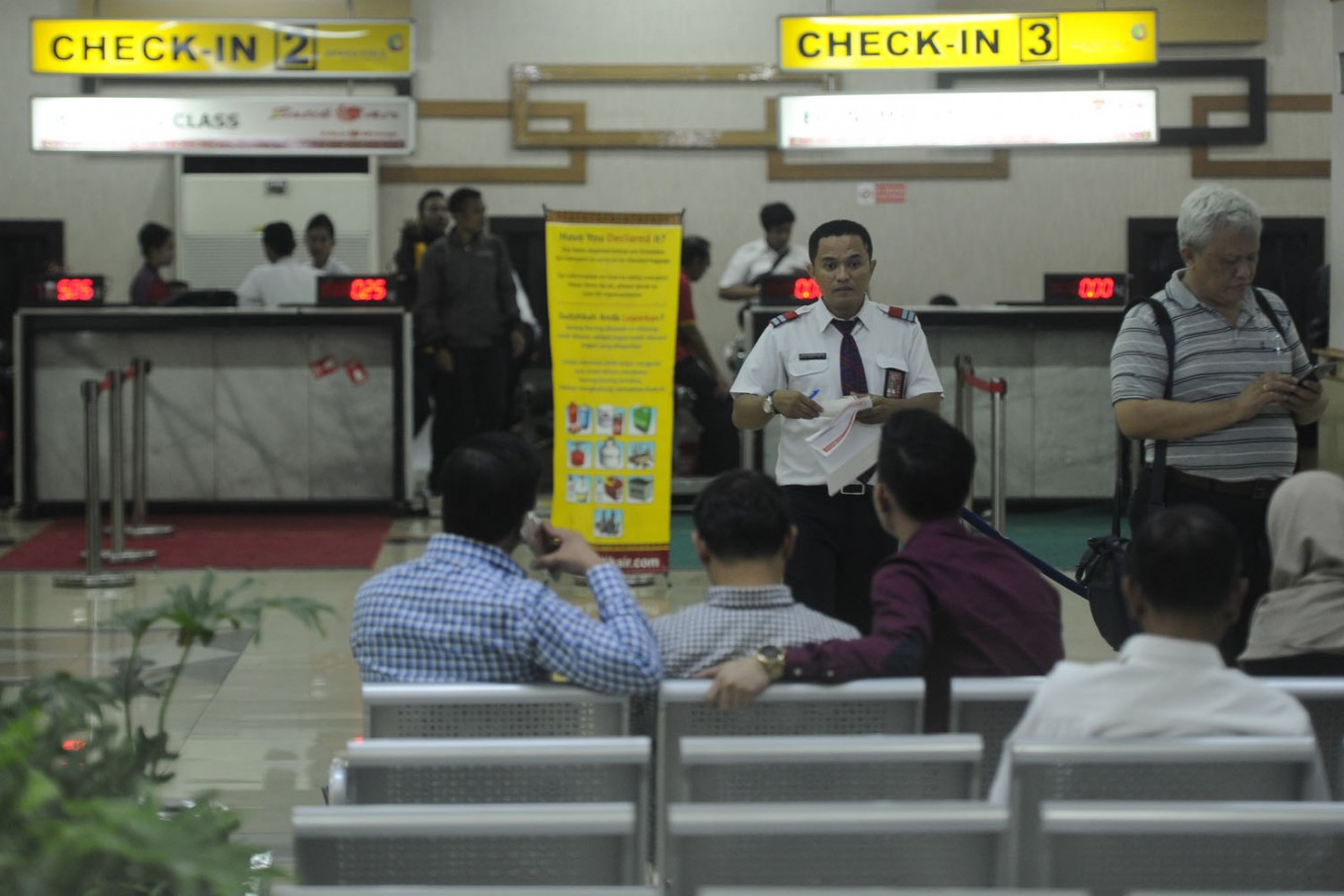 A flight operations officer checks the data of Batik Air passengers after their flight was cancelled following a collision with a Transnusa Air plane at Halim Perdanakusuma airport, in Jakarta, on April 4.
