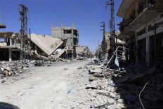 Destruction, razed monastery left behind by IS in Syria town